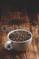 Roasted coffee beans in cup