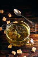 Cup of green tea with brown tea sugar