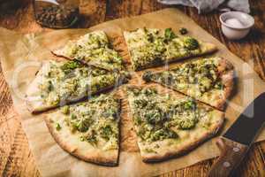 Slices of pizza with broccoli and cheese