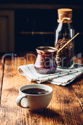 Cup of black coffee on wooden table