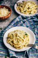 Two Portions of Pasta with Alfredo Sauce