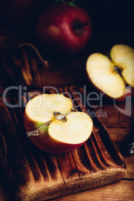 Halved Red Apple on Cutting Board