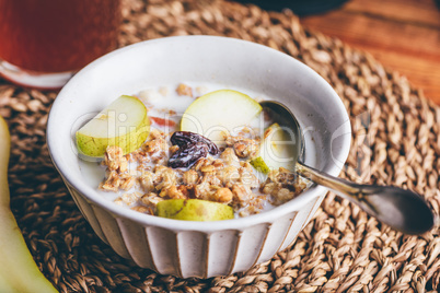 Delicious Granola with Pear and Raisins In Bowl