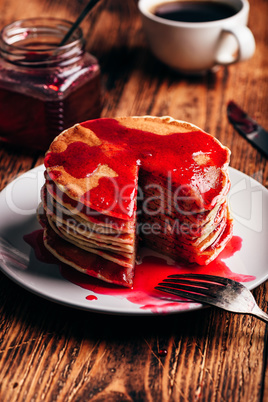 Stack of american pancakes with red berry jam