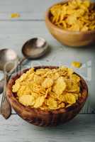 Rustic bowls of cornflakes with spoons