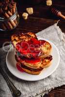 Stack of french toasts with berry syrup