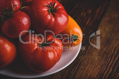 Fresh red and yellow tomatoes on plate