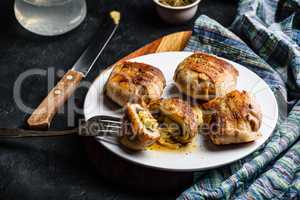 Bacon-wrapped button mushrooms stuffed with cheese
