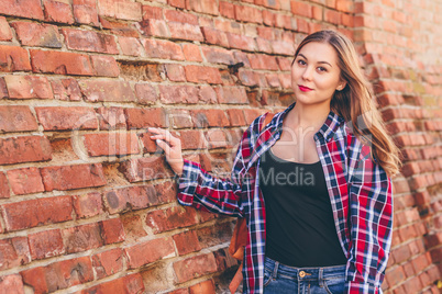 Portrait of young woman in shirt and jeans