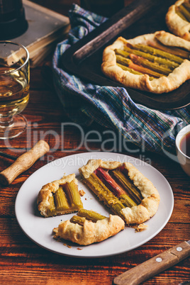 Sliced rhubarb mini galette on white plate