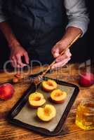 Prepare for baking halves of ripe peaches with honey