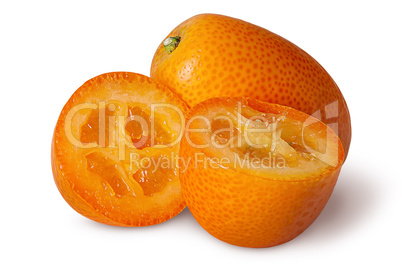 Halves and whole ripe kumquat isolated on white
