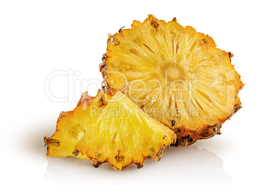 Half pineapple and slices isolated on white