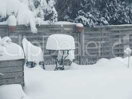 Heavy snowfall. Garden furniture is covered with a lot of snow