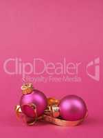 Pink vintage Christmas baubles on a pink background with space f