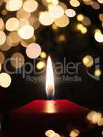 Candle light withs blurred Christmas lights