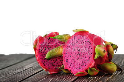 Two halves of dragon fruit on planks