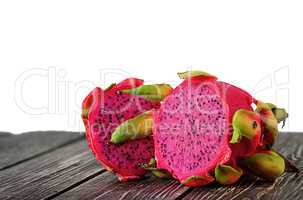 Two halves of dragon fruit on planks