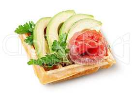 French waffle with avocado and salmon isolated on white