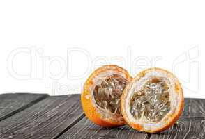 Two halves of tamarillo on wooden table