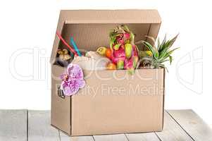 Tropical fruits in cardboard box isolated on white