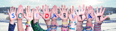 Kids Hands Holding Word Solidaritaet Means Solidarity, Snowy Winter Background