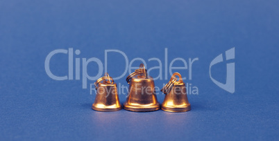 Three small golden bells on a blue background