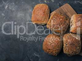 Organic whole grain rolls on a dark background