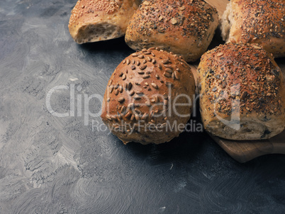 Organic whole grain rolls on a dark background