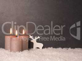 Third Advent candle burns, dark stone background