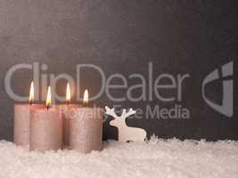 Fourth Advent candle burns, dark stone background
