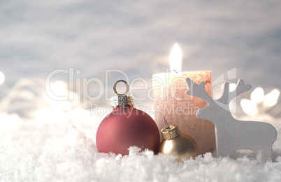 Christmas decoration in snow with candle, selective focus on gol