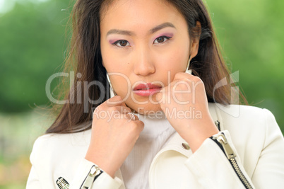 Pretty Asian woman with white jacket. VI