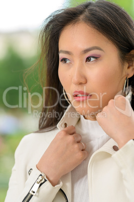 Pretty Asian woman with white jacket. V