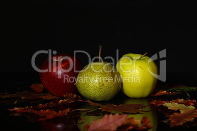 Ripe apples and pears lie on the table