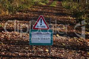 Forest. Text in German: Logging. Acces denied. Forestry work - danger to life.