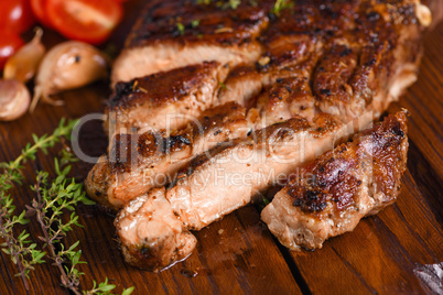 Sliced fried pork steak on a wooden board