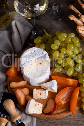 Cheese camembert with fruit and wine