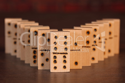 Wooden dominoes lined up on a table
