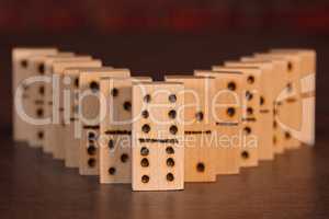Wooden dominoes lined up on a table