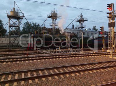 steam locomotive on rails at dry morning
