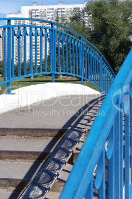 bridge over pond in park at dry sunny summer day