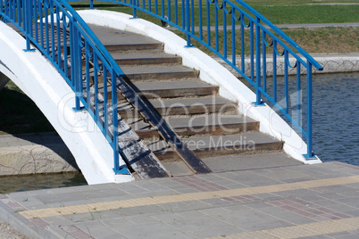 bridge over pond in park at dry sunny summer day