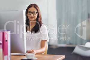 Shes an asset to the company. Cropped portrait of an attractive young businesswoman working at her desk.