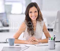 Shes made it. Shot of an attractive businesswoman sitting at her desk in an office.