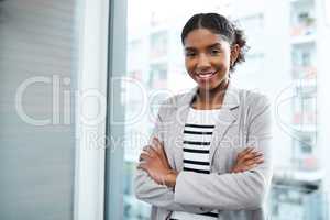 Stand firm in the face of business. Portrait of a confident young businesswoman working in a modern office.