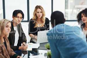 Productivity is priority in their meetings. Shot of a group of colleagues having a brainstorming session in a modern office.