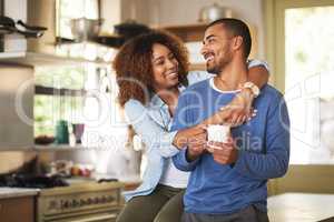 Honey, youre the best. Shot of a happy young couple feeling relaxed in the at home.