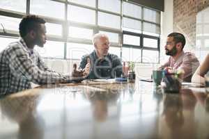 Meetings are a great way to communicate. Shot of a team of businesspeople having a meeting in an office.