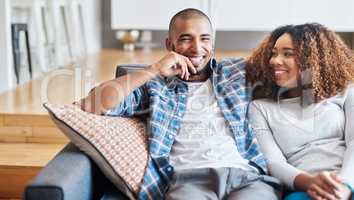 Theres no substitute for spending time. Portrait of a happy young couple relaxing together on the sofa at home.